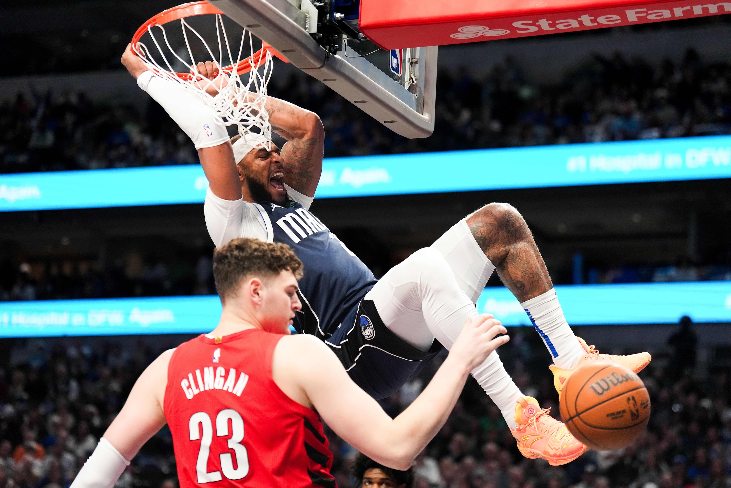 Dallas Mavericks center Daniel Gafford (21) dunks the ball past Portland Trail Blazers...