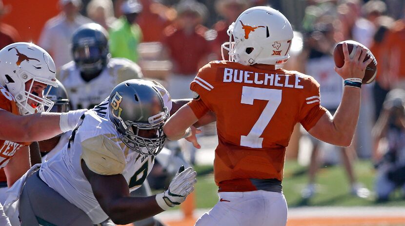 Baylor defensive tackle Ira Lewis (97) puts a pressure on Texas quarterback Shane Buechele...