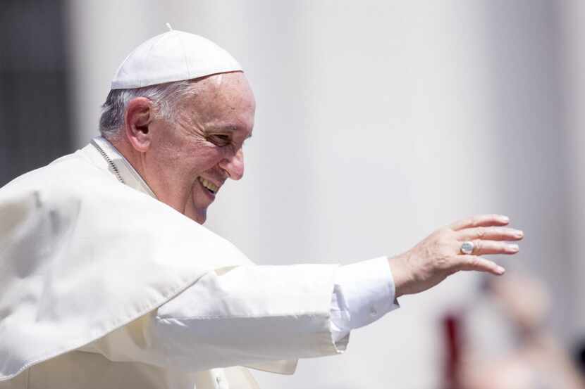  Pope Francis waves to the faithful as he leaves at the end of his weekly general audience,...
