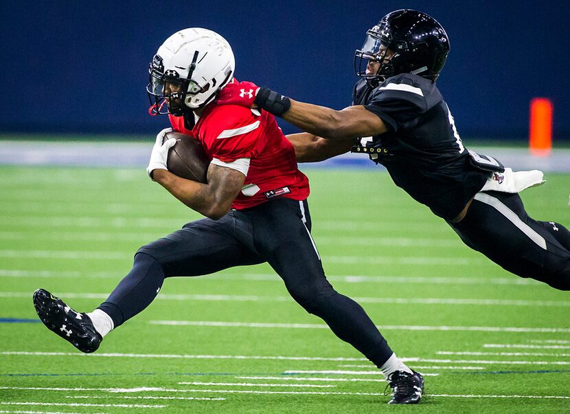 Texas Tech running back Tre King (24) is brought down by defensive back Vaughnte Dorsey (15)...