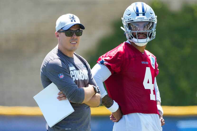Dallas Cowboys quarterback Dak Prescott (4) talks with offensive coordinator Kellen Moore...
