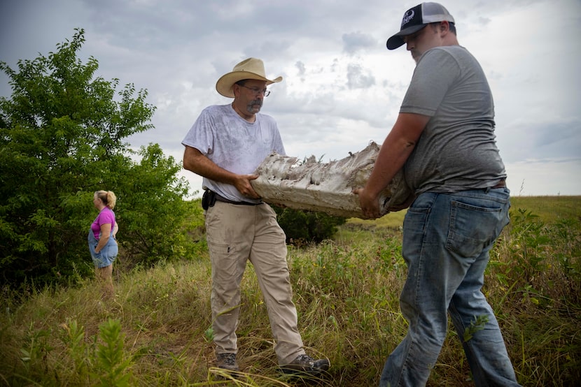 Luke Sullivan (right), a Upper Trinity Regional Water District summer intern, helps Ron...