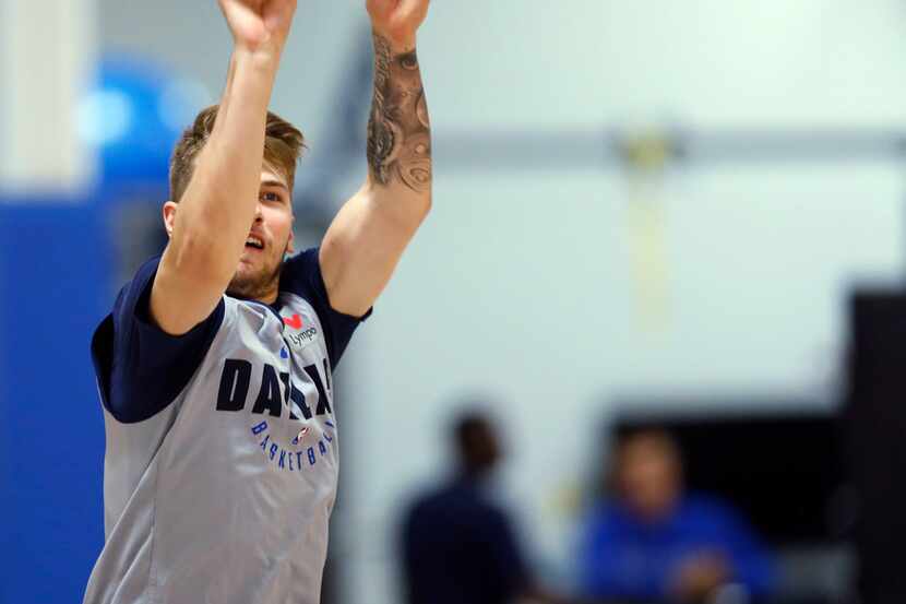 Dallas Mavericks Luka Doncic (77) shoots a shot from half court after practice after...