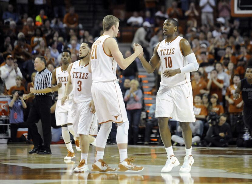 Texas Longhorns guard Javan Felix (3) and forwards Connor Lammert (21) and Jonathan Holmes...