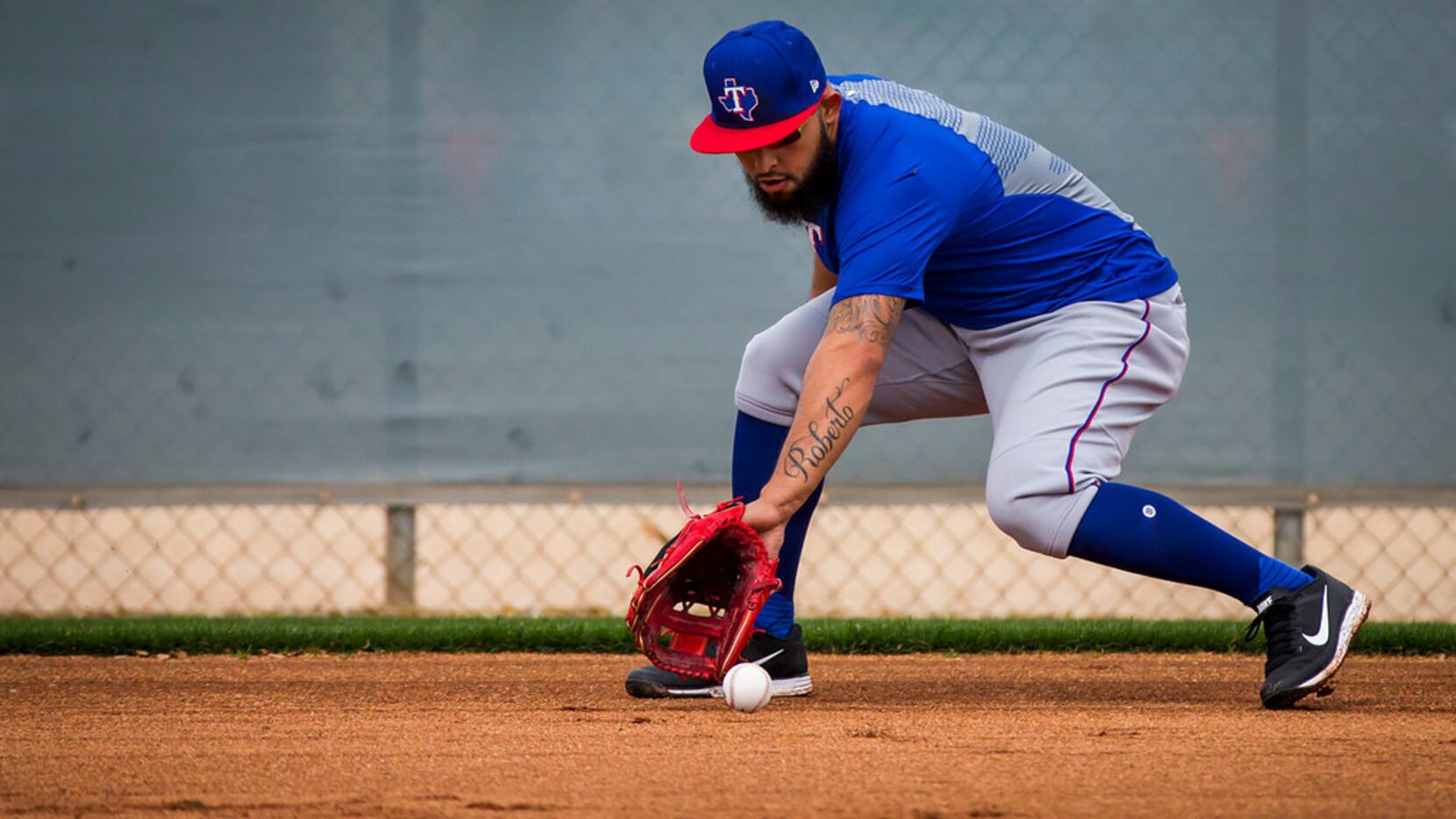 Texas Rangers second baseman Rougned Odor fields a grounder during infield practice during a...