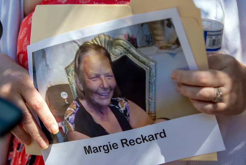 Hilda Reckard held a picture of her mother-in-law, Margie Reckard, outside the federal court...