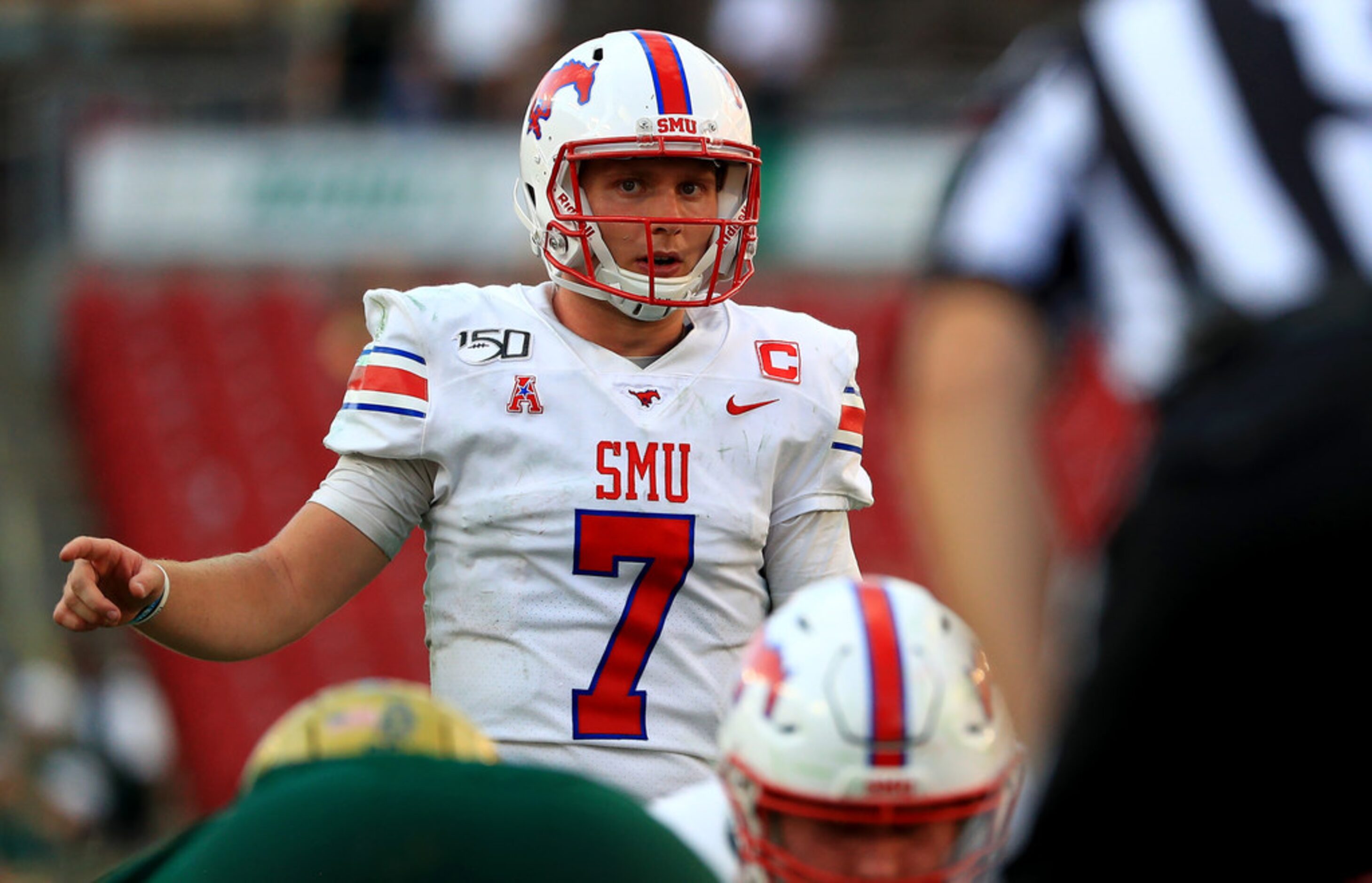 TAMPA, FLORIDA - SEPTEMBER 28: Shane Buechele #7 of the Southern Methodist Mustangs calls a...