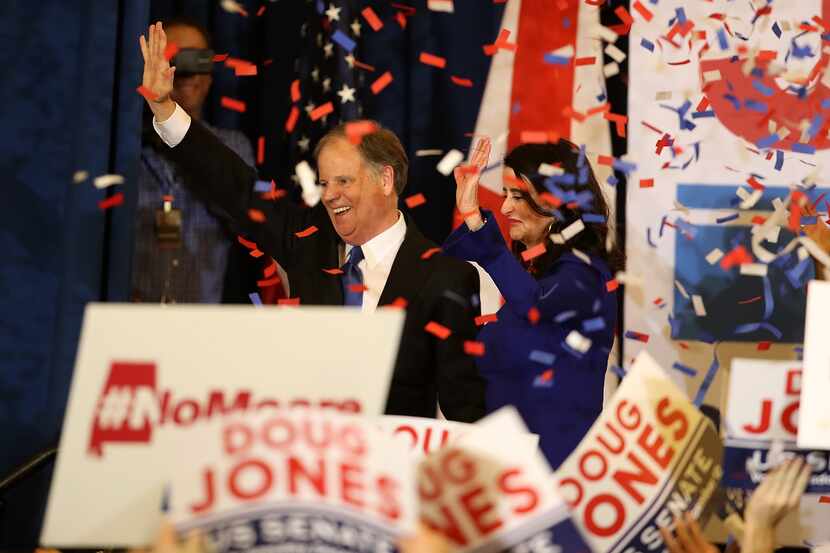 Doug Jones, with his wife, Louise, celebrated his victory in Birmingham, Ala., Tuesday night. 