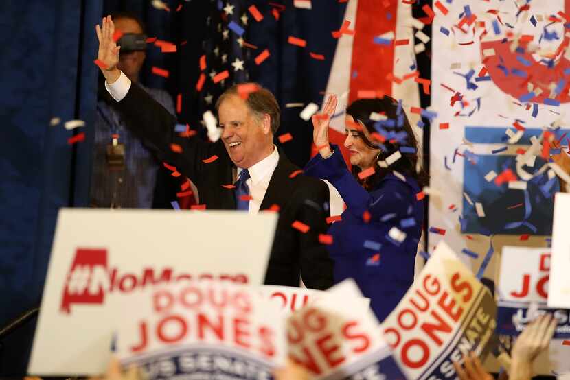 Doug Jones, with his wife, Louise, celebrated his victory in Birmingham, Ala., Tuesday night. 