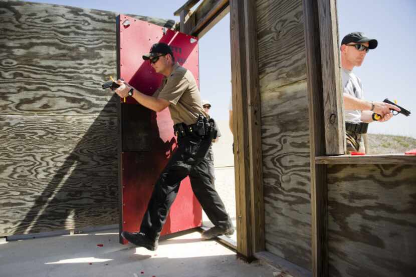 Patrol Sgt. John Dean (left) of the Kyle Police Department and Officer Donovan Hunter of the...