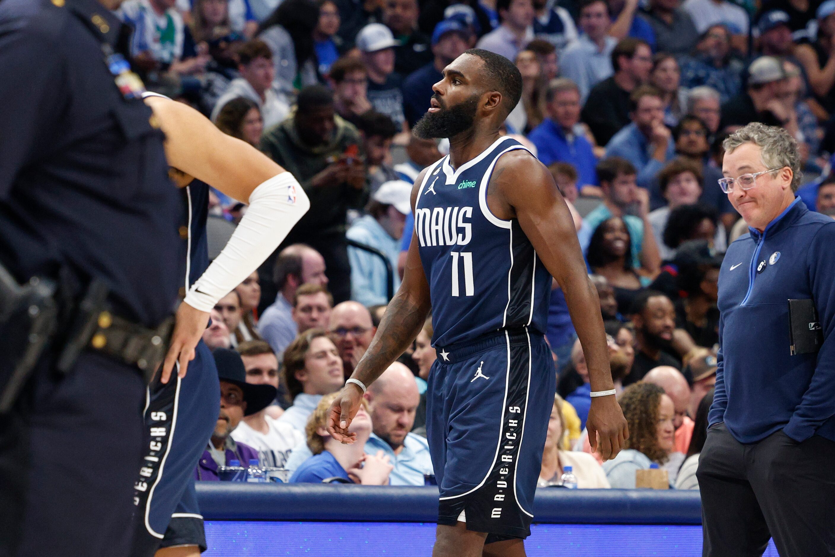 Dallas Mavericks forward Tim Hardaway Jr. (11) limps off the court after slipping on the...