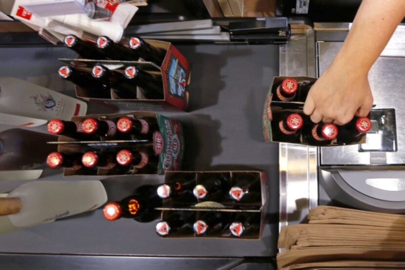 Alicia Richmond rings up some beer at the new Total Wine & More store in Plano.

