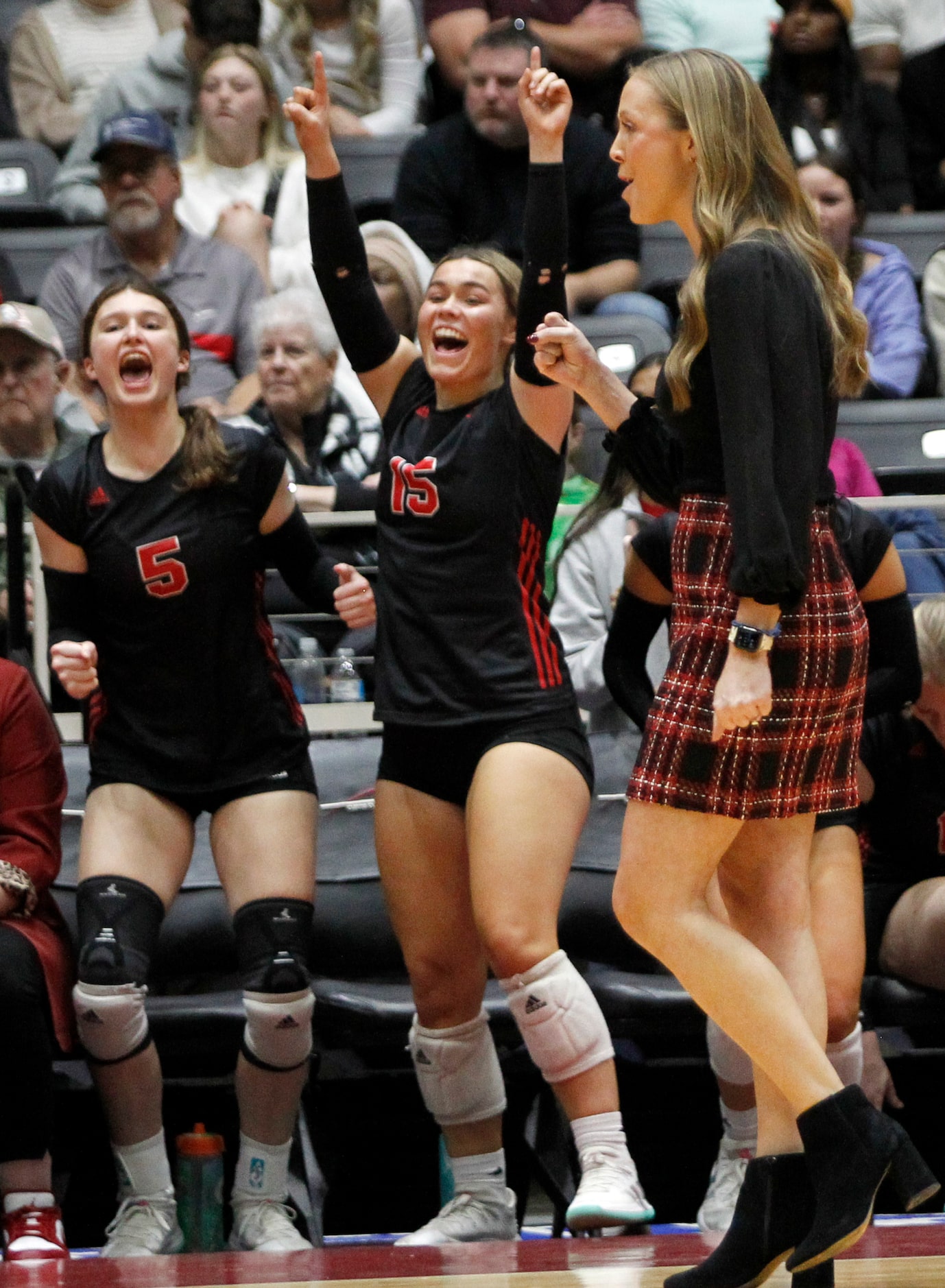 Lovejoy head coach Natalie Puckett, right, pumps her fist as leopards players Caroline...