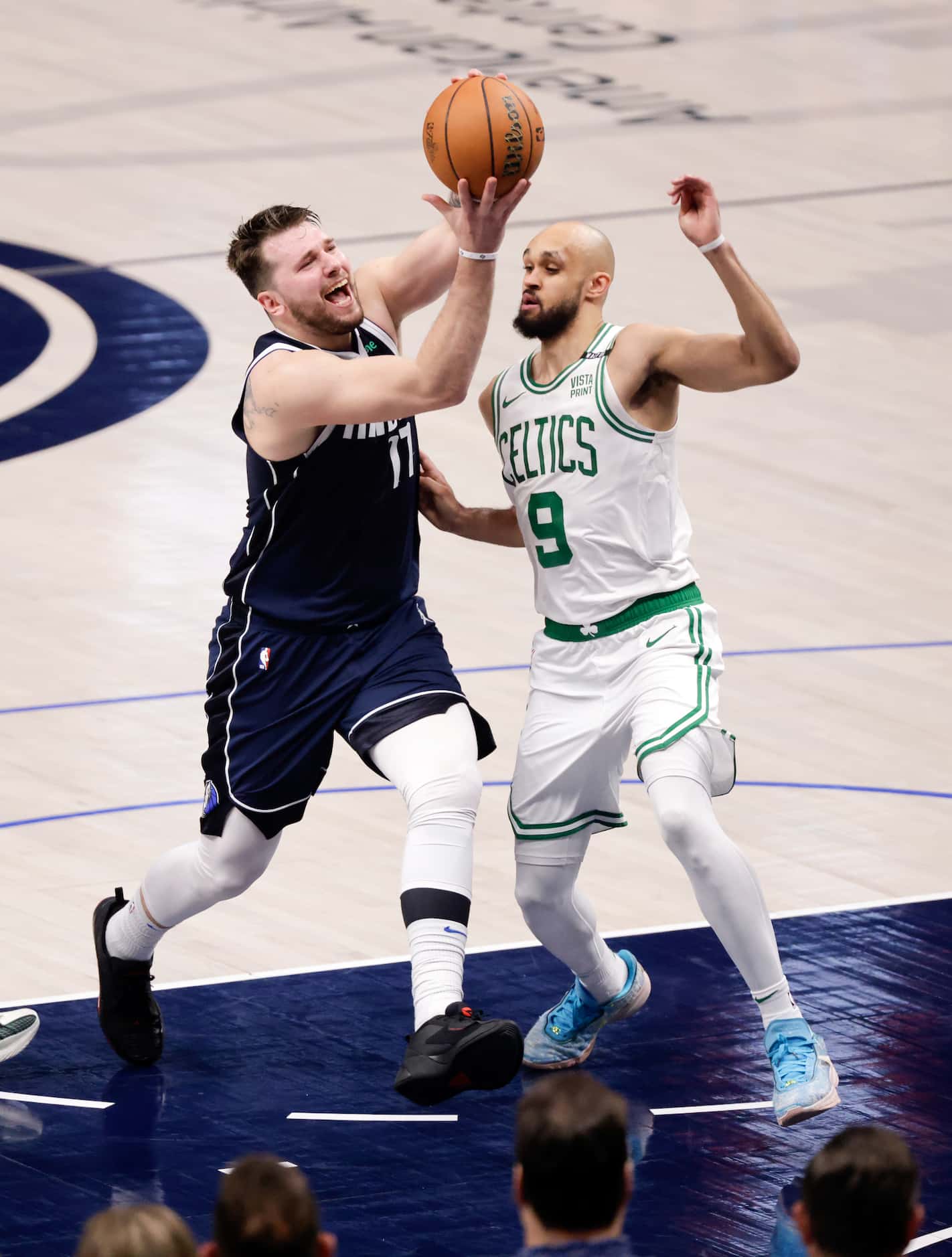 Dallas Mavericks guard Luka Doncic (77) tries to draw a foul from Boston Celtics guard...