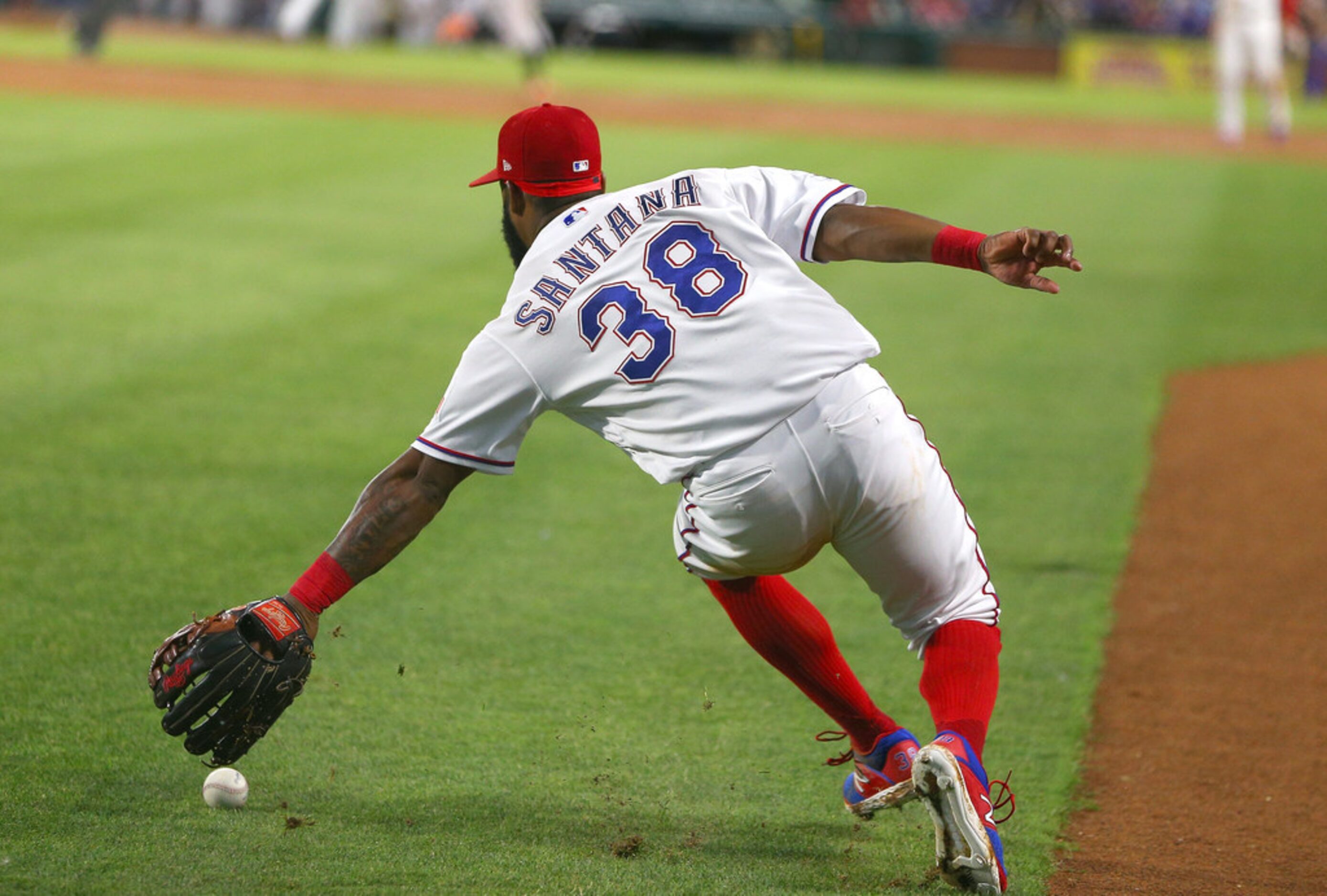 ARLINGTON, TX - JUNE 06: Danny Santana #38 of the Texas Rangers fields a ground ball in the...