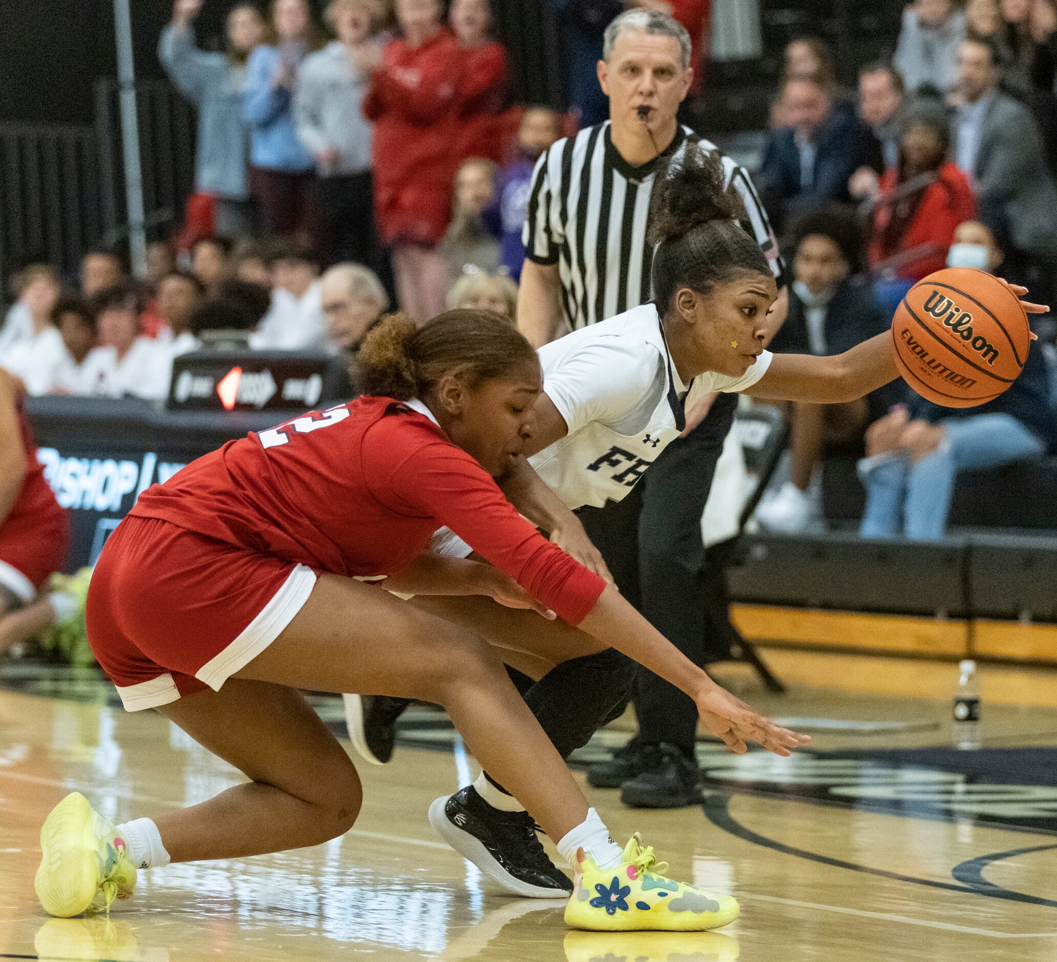 John Paul II High School Sydni Greene (12) lunges to gain possession of the ball from Bishop...