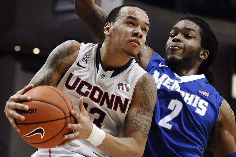FILE - In this Feb. 15, 2014 file photo, Connecticut's Shabazz Napier, left, drives to the...