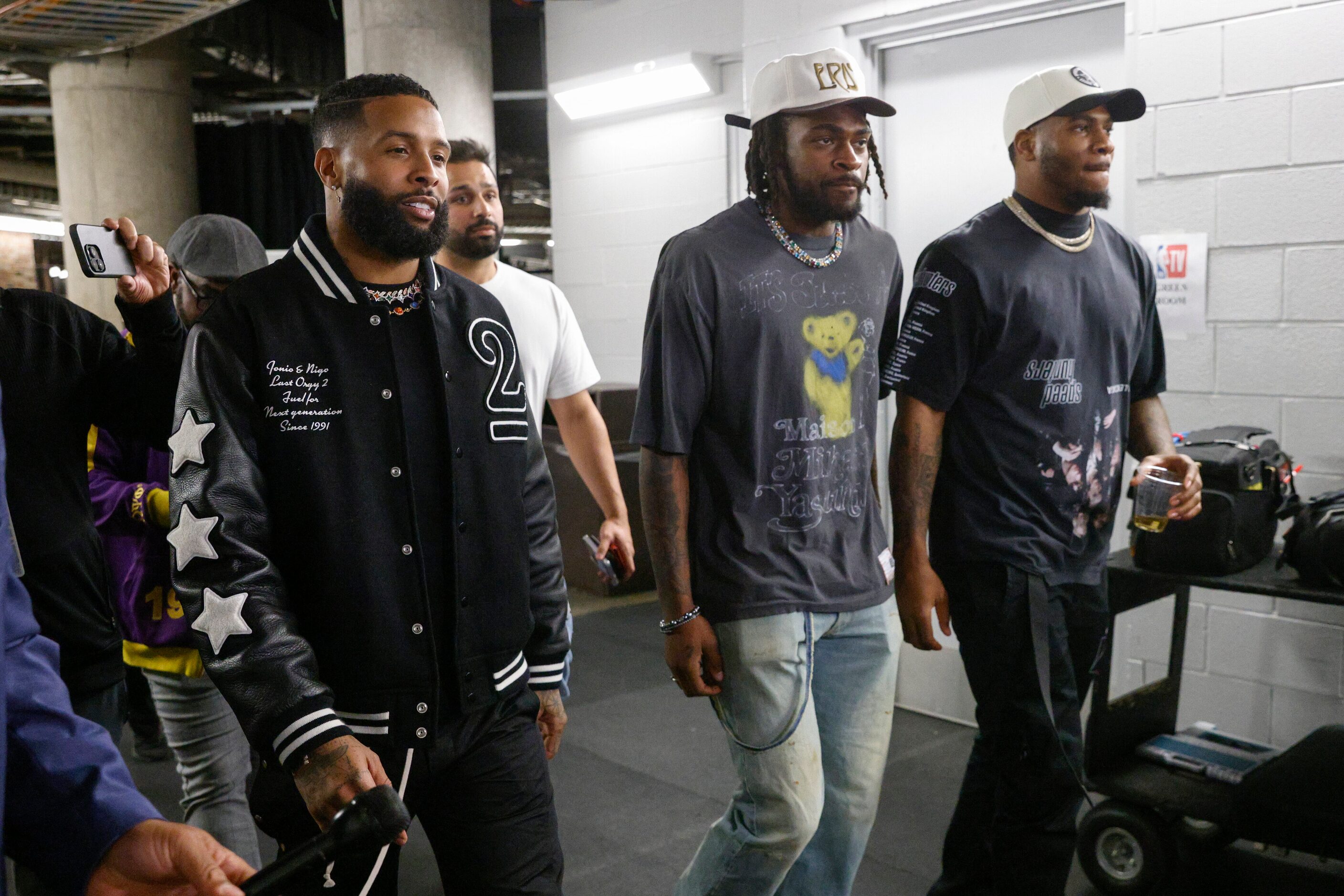 NFL free agent Odell Beckham Jr. (left) walks with Dallas Cowboys players Trevon Diggs...