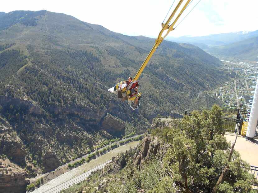 Patrons swing over Glenwood Canyon at Glenwood Caverns Adventure Park on top of Iron...
