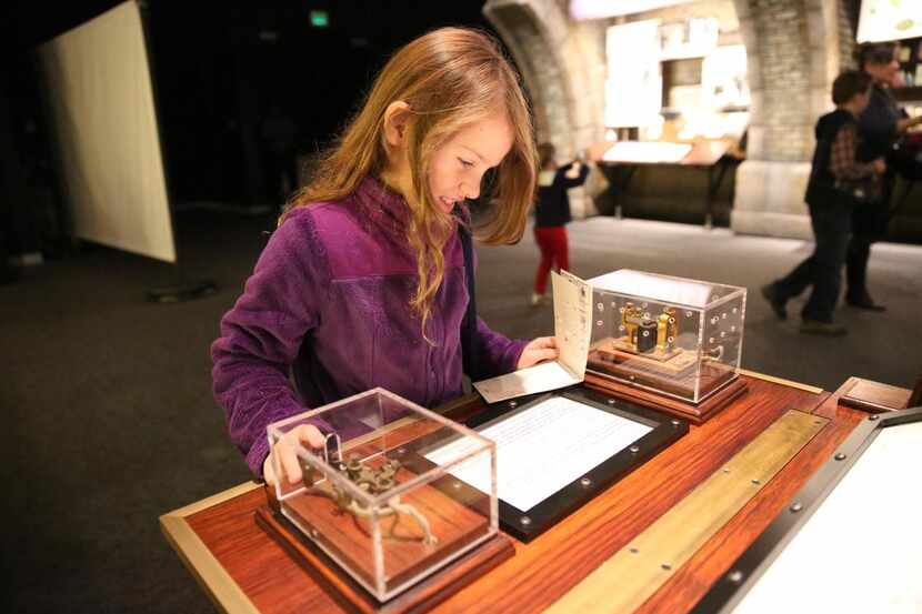 
THE EXHIBIT lets kids become a detective using their book of clues and powers of...
