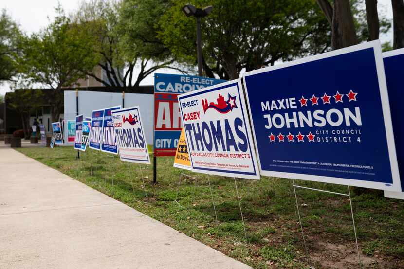 Campaign signs for Dallas City Council candidates fill the grass areas outside of the Oak...