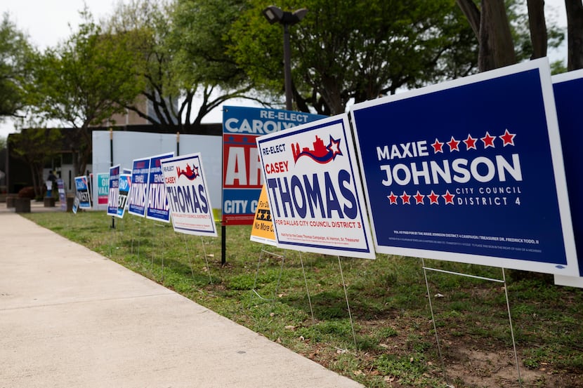 Campaign signs for Dallas City Council candidates\ fill the grass areas outside of the Oak...