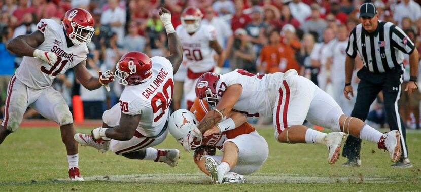 Texas Longhorns quarterback Shane Buechele (7) is sacked by Oklahoma Sooners defensive...