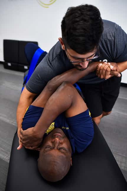 Stretch practitioner Shan Hussain works on client Sergeant Nathan Wilson, of the Dallas...