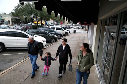 Dave Krainbucher (from left) walks with his granddaughter Charlotte Camp, 4, with his wife...