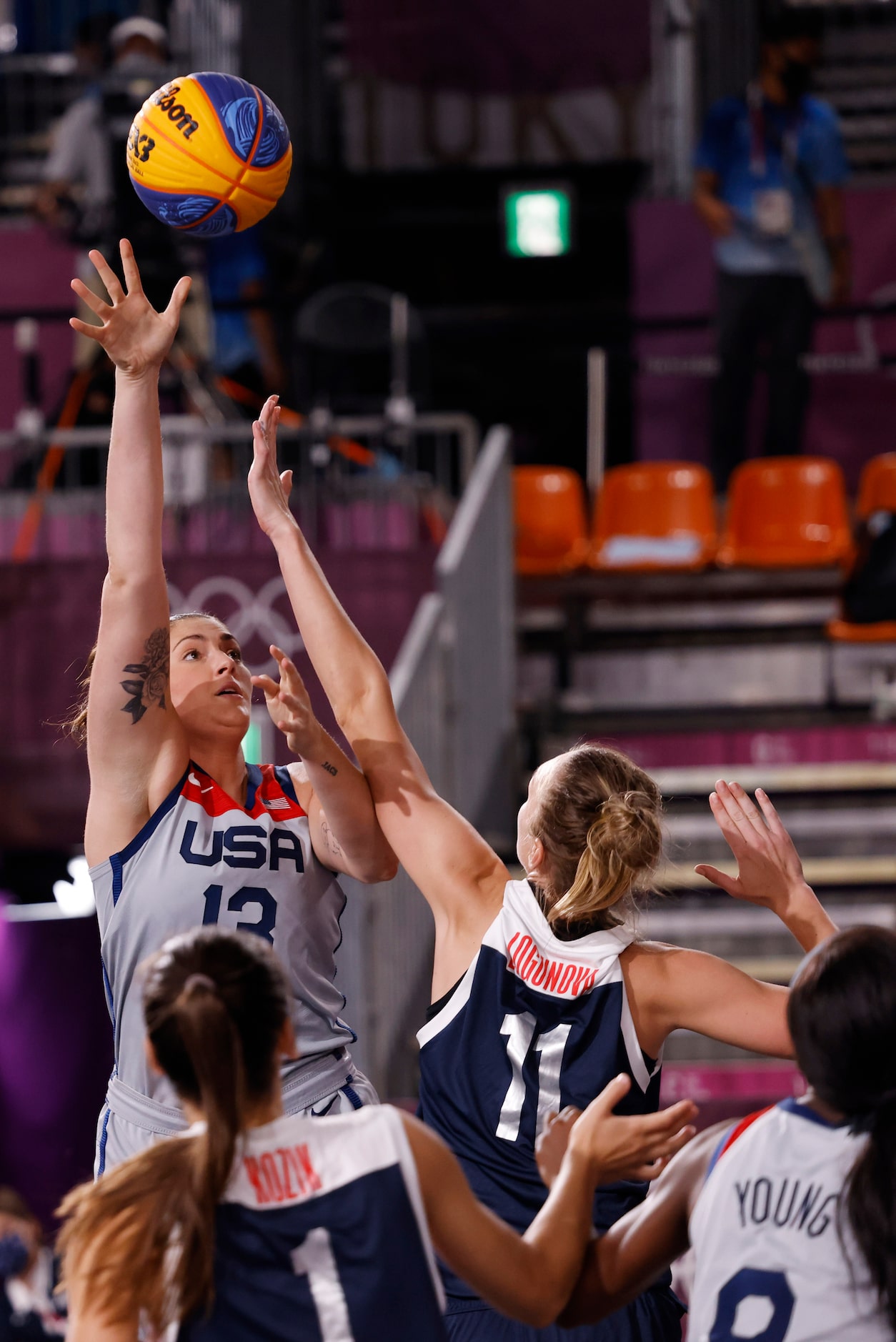 USA’s Stefanie Dolson (13) shoots over the arms of ROC’s Anastasiia Logunova (11) during the...