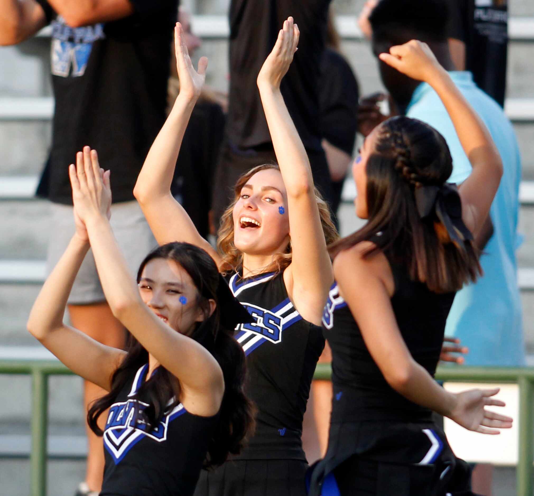 Plano West cheerleaders react to a long rushing touchdown during the opening possession of...