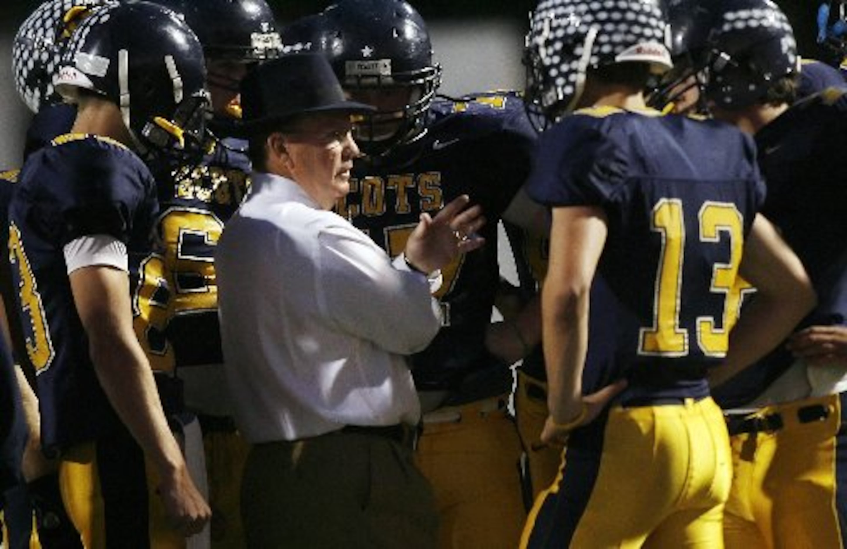 Highland Park head coach Randy Allen talks with quarterback Luke Woodley (13) and the...