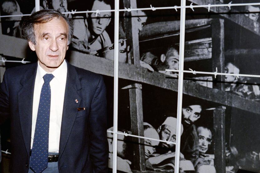 Nobel Peace prize winner and writer Elie Wiesel stands in front of a photo of himself...