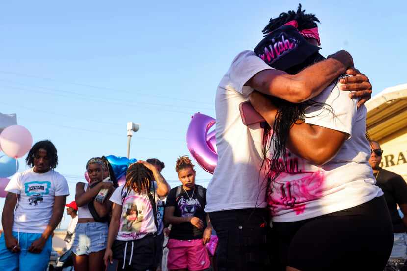 Dequalyn Levels holds cousin Jontrenae Johnson (right) who began crying while talking to the...