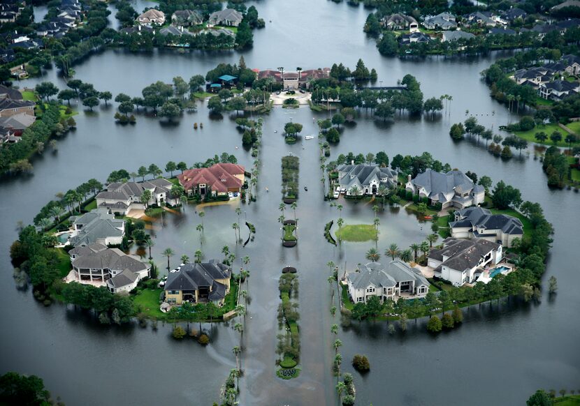 Flood waters have risen into the Lakes on Eldridge North neighborhood near the Addicks...