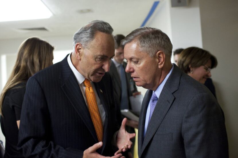 Sens. Chuck Schumer (D-N.Y.), left, and Lindsey Graham (R-S.C.), two the members of the...