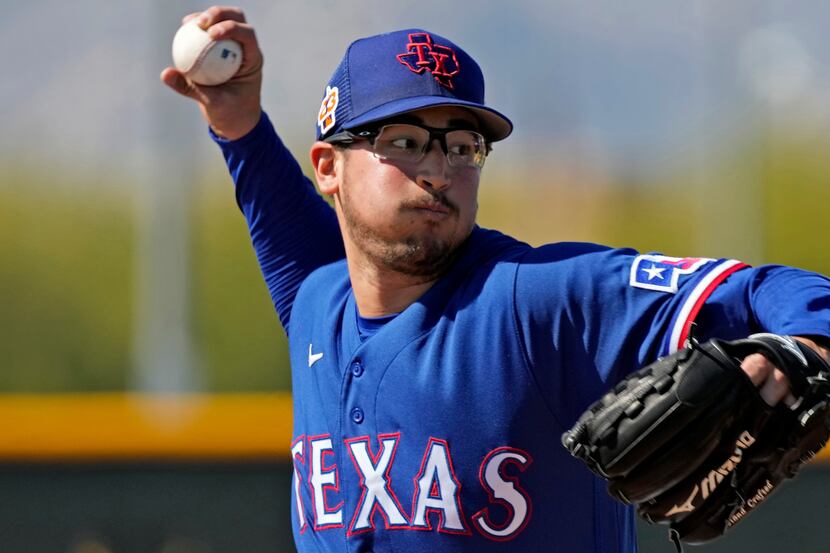 Texas Rangers pitcher Dane Dunning throws during spring training baseball practice Monday,...