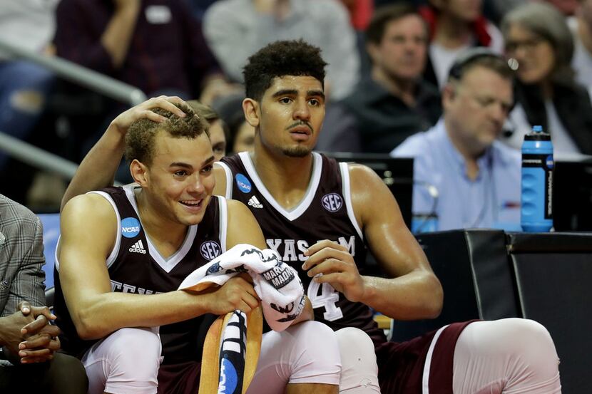 CHARLOTTE, NC - MARCH 18:  DJ Hogg #1 and teammate Tyler Davis #34 of the Texas A&M Aggies...