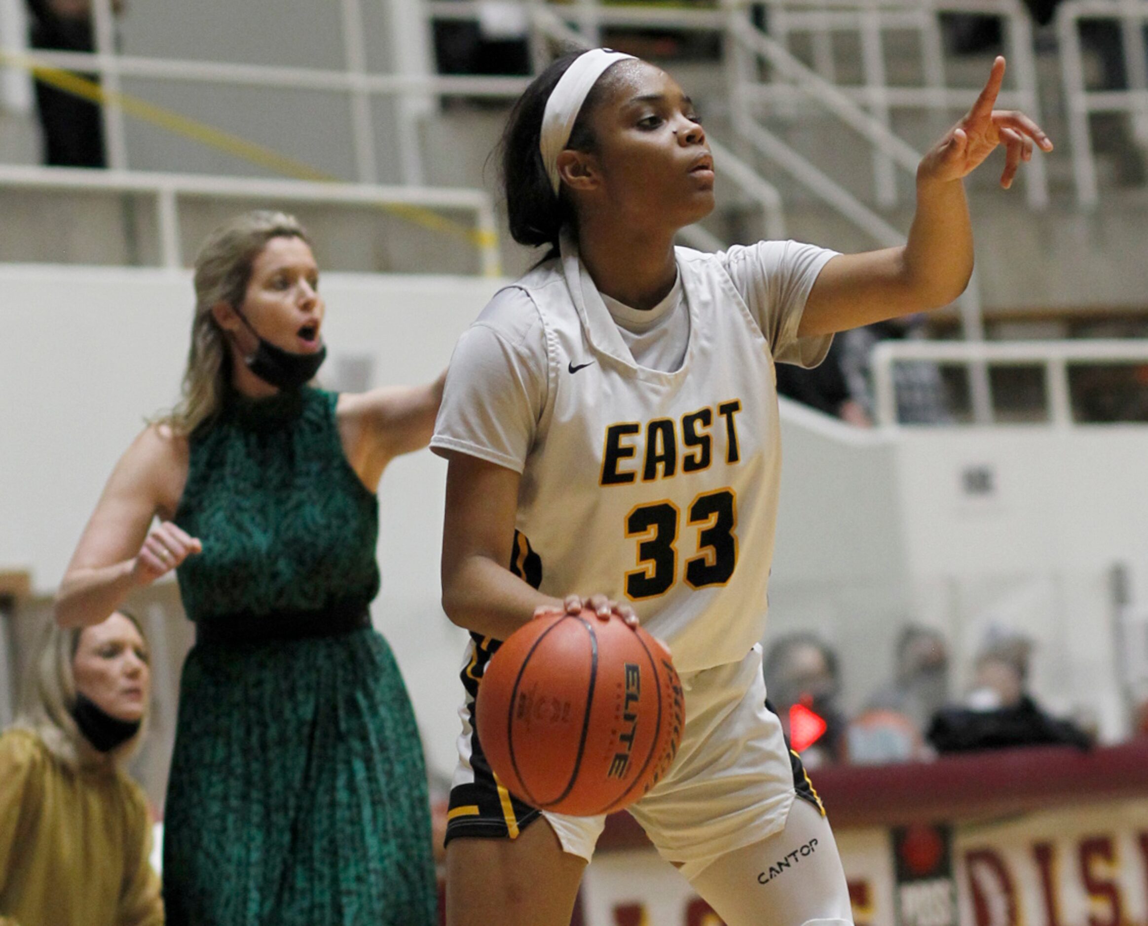 Plano East guard Tiana Amos (33) visually peruses all of her passing options during first...