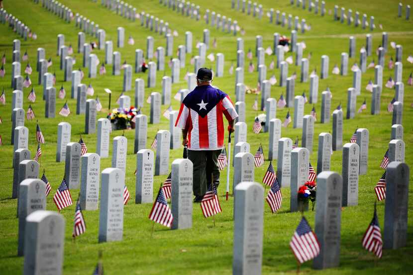 Johnny Torres, 65, served thirteen years in the Army, looks for the headstone of his great...