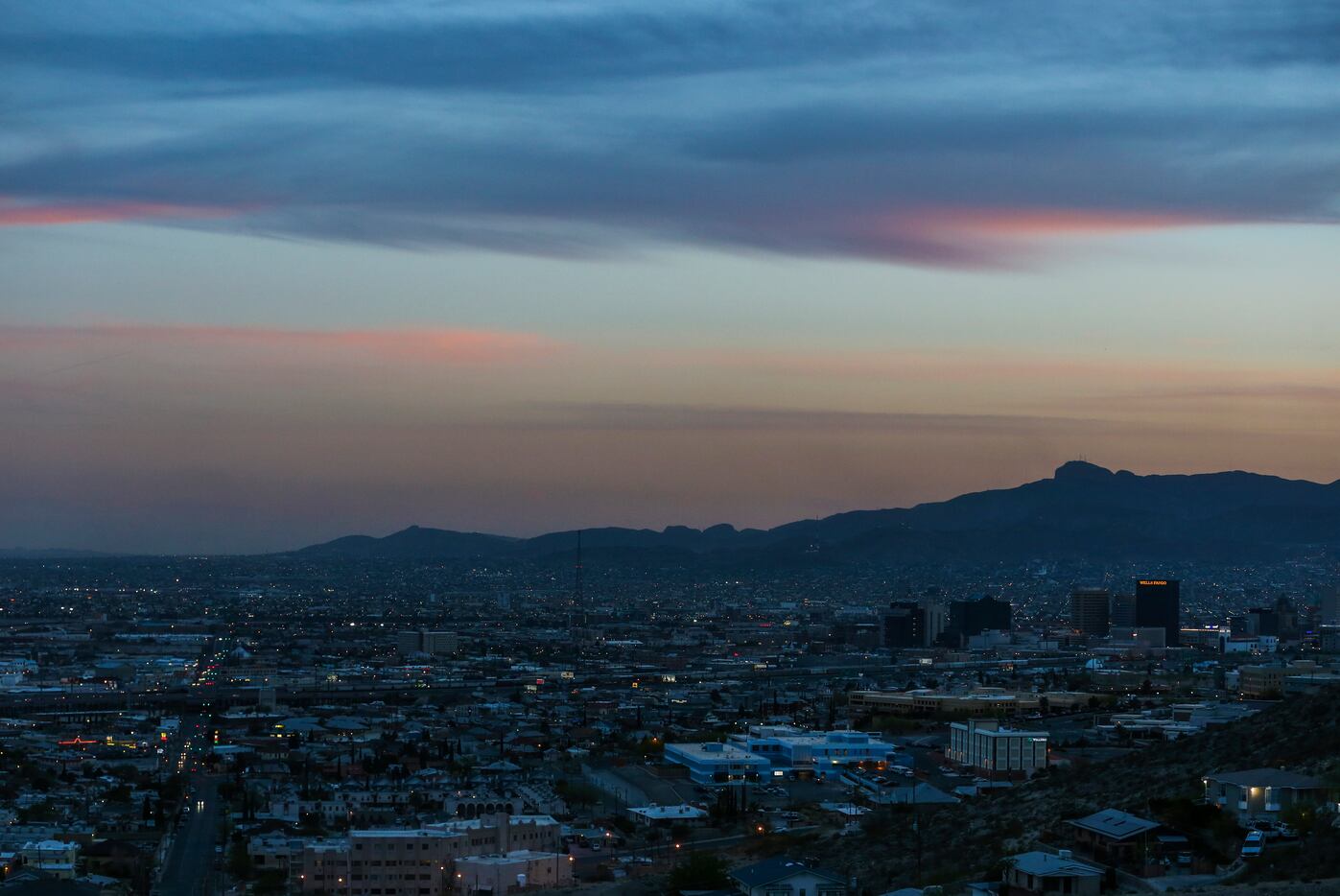 The sun sets over the sprawling border cities of El Paso, Texas (foreground), and Ciudad...