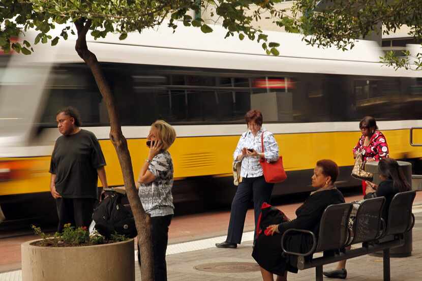 DART riders wait for their train at the Akard stop in downtown Dallas, (Tom Fox/The Dallas...