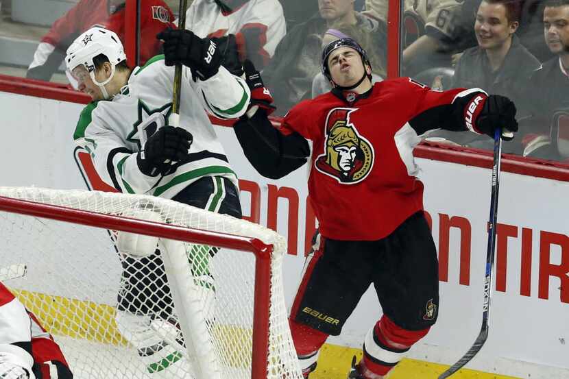 Ottawa Senators' Jean-Gabriel Pageau (44) reacts after being checked by Dallas Stars'...