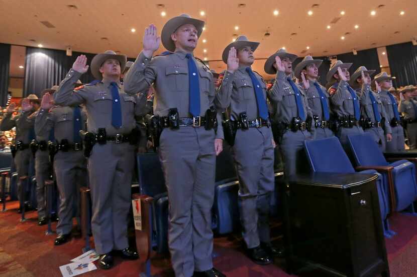 Members of the 155th trooper training class swear an oath during the 155th trooper training...