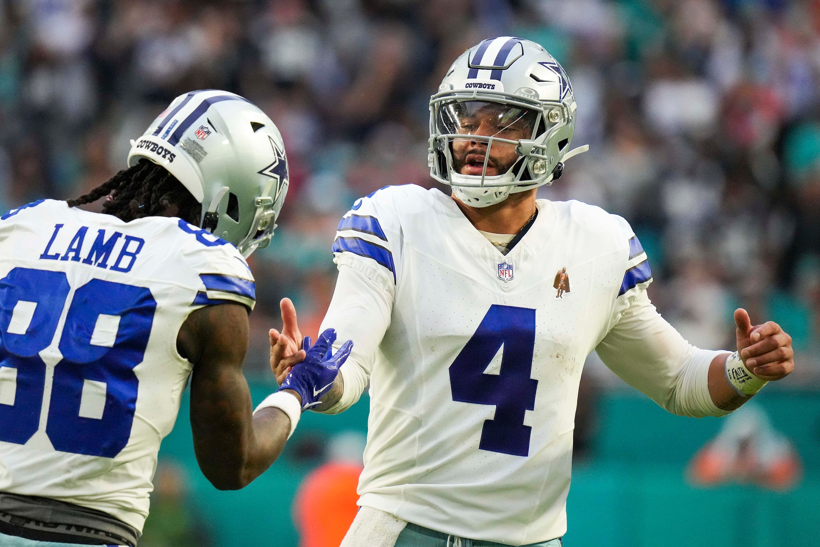 Dallas Cowboys wide receiver CeeDee Lamb (88) celebrates with quarterback Dak Prescott (4)...