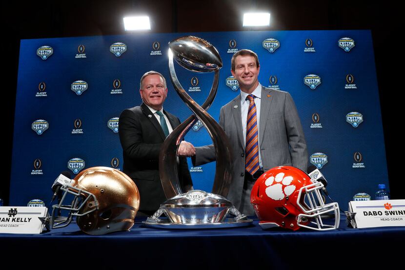 Notre Dame head coach Brian Kelly, left, and Clemson head coach Dabo Swinney shake hands and...