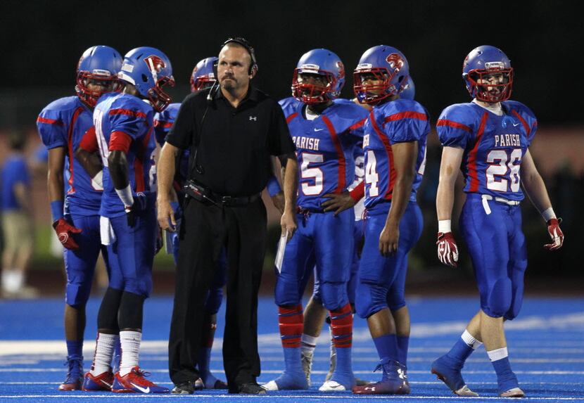 TXHSFB Parish Episcopal head coach Scott Nady huddles with his team during a stop in play in...