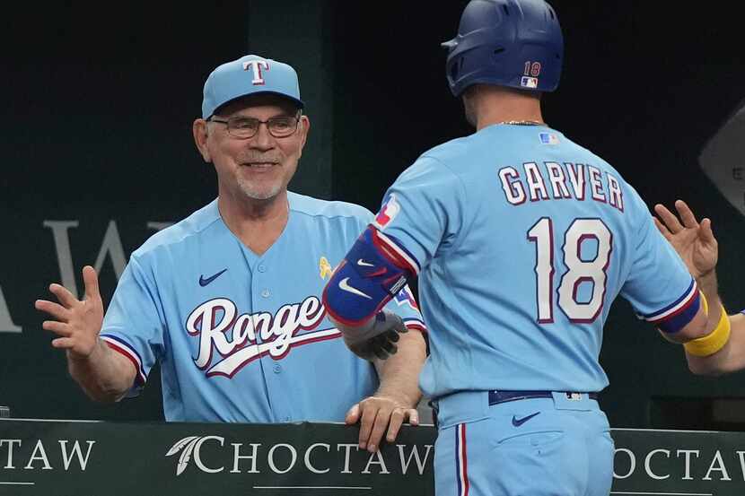 FILE - Texas Rangers manager Bruce Bochy, left, congratulates Mitch Garver after his solo...