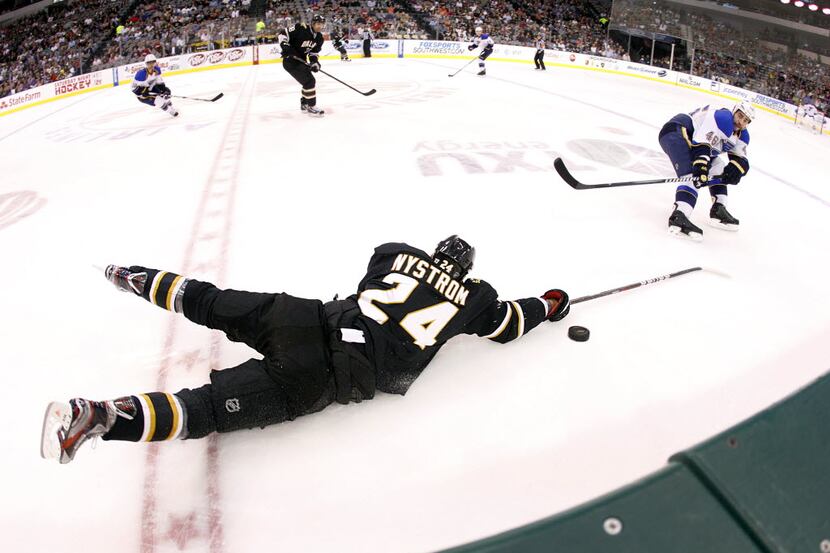 Dallas Stars left wing Eric Nystrom (24) dives at a puck returned by St. Louis Blues...