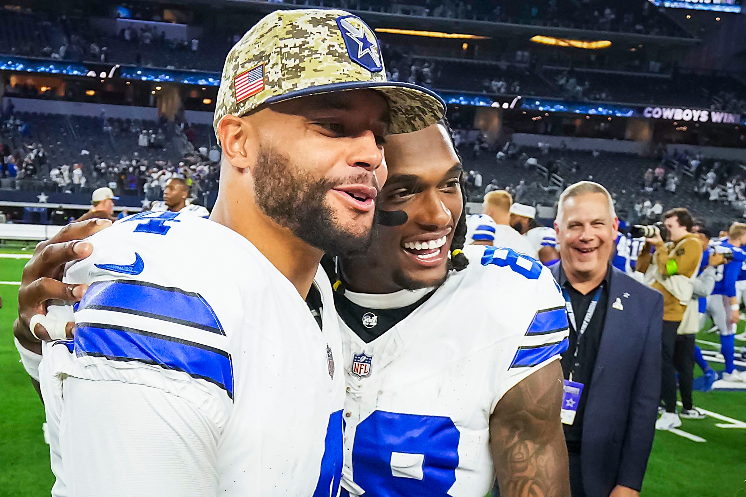 Dallas Cowboys wide receiver CeeDee Lamb (88) hugs quarterback Dak Prescott (4) after a...